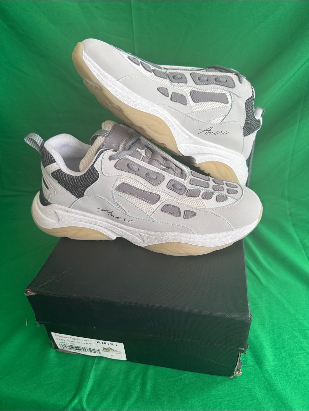 New! AMIRI “Bone Runner” sneakers in a grey and white colorway.